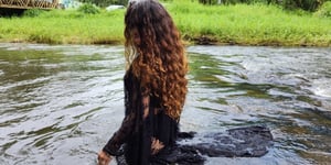 Juliana Hamon, LMFT (California) wades in a river in Kauai