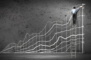 Man on step ladder measuring growth