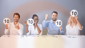 group of marketers holding up signs scoring a competition