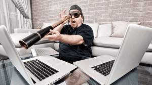 modern pirate looking through telescope at his computer