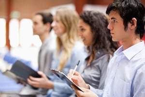 Business people taking notes during a presentation