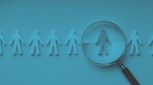 people icons being examined with a magnifying glass