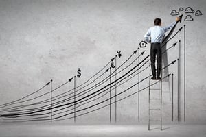 Back view image of businessman drawing graphics on wall